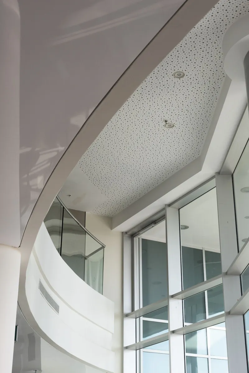 Curved white ceiling in a commercial lobby. Photograph by STAS PRO