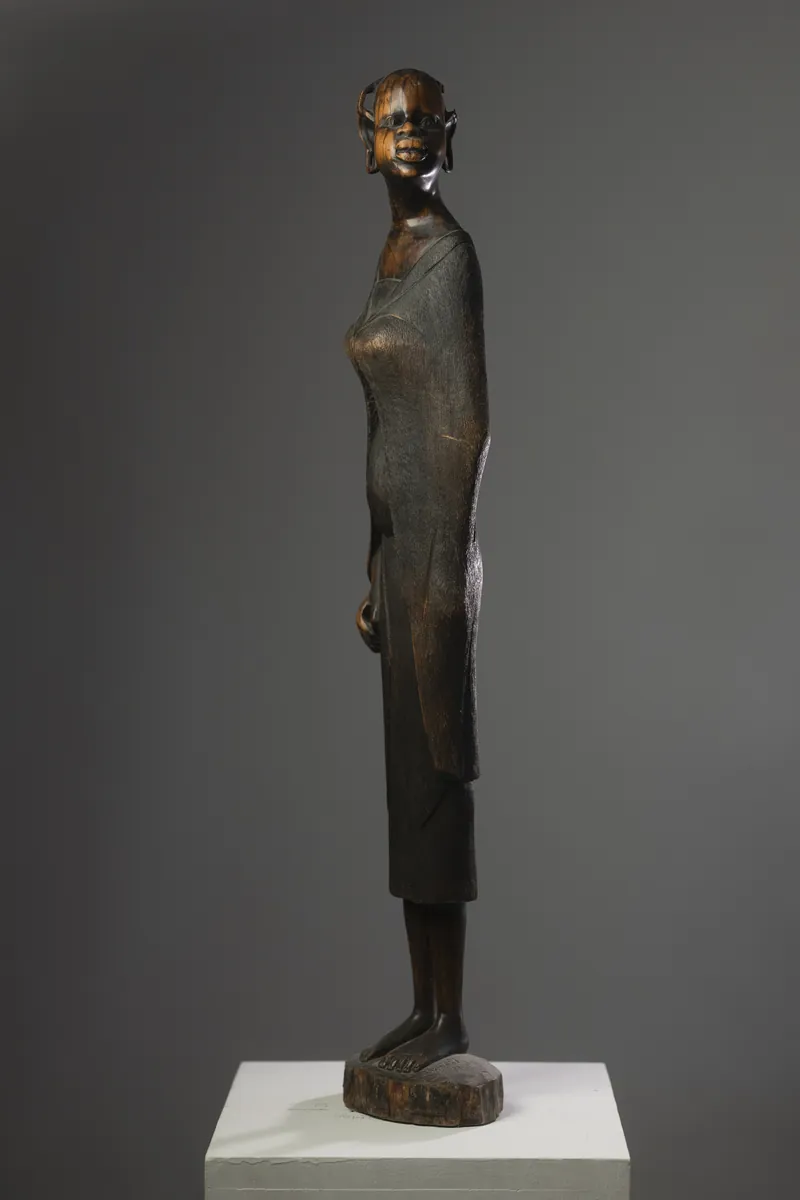 Tall bronze figure on a plinth. Photograph by STAS PRO