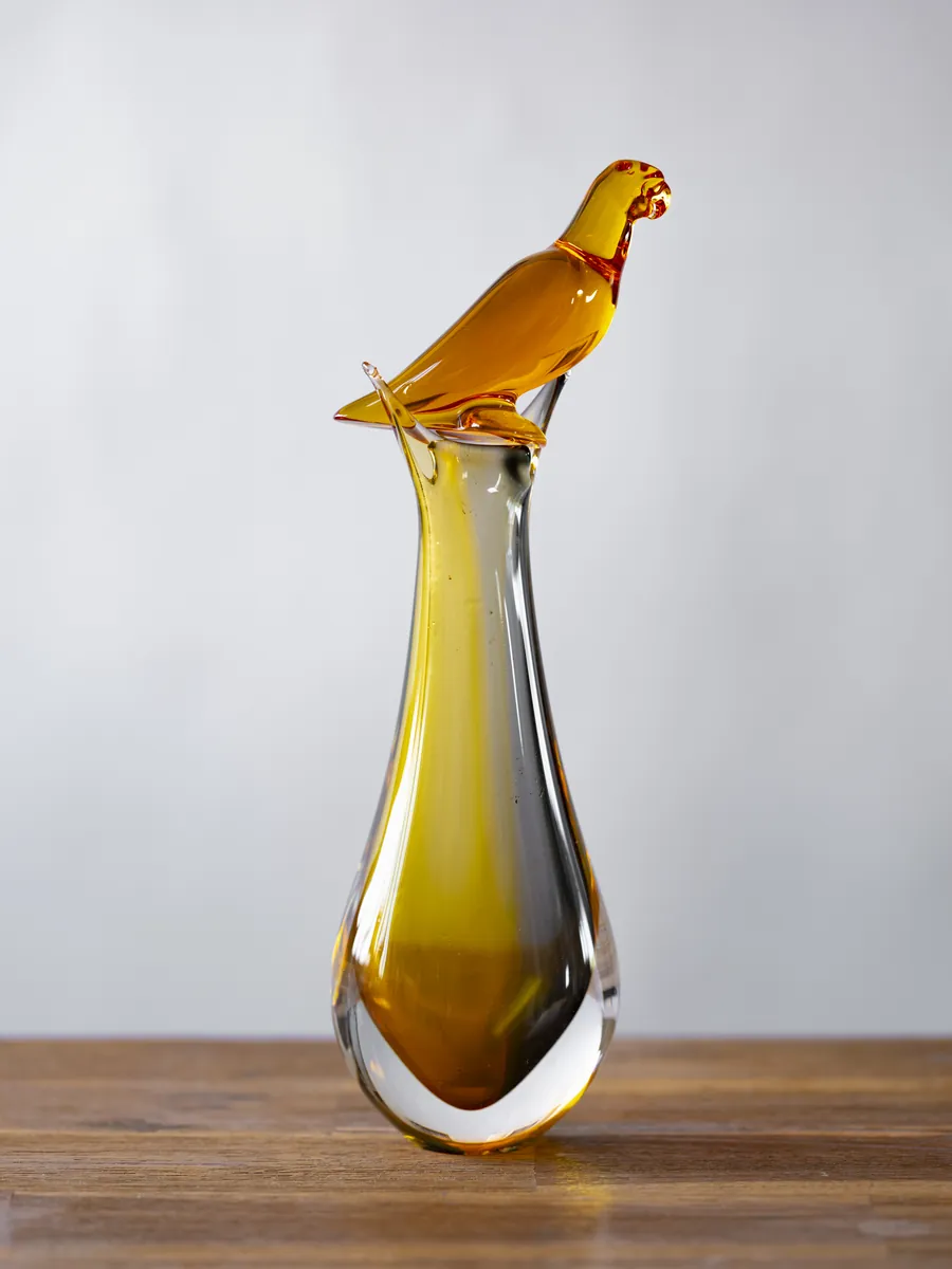Amber glass vase with a bird, photographed on wood. Object photography by STAS PRO