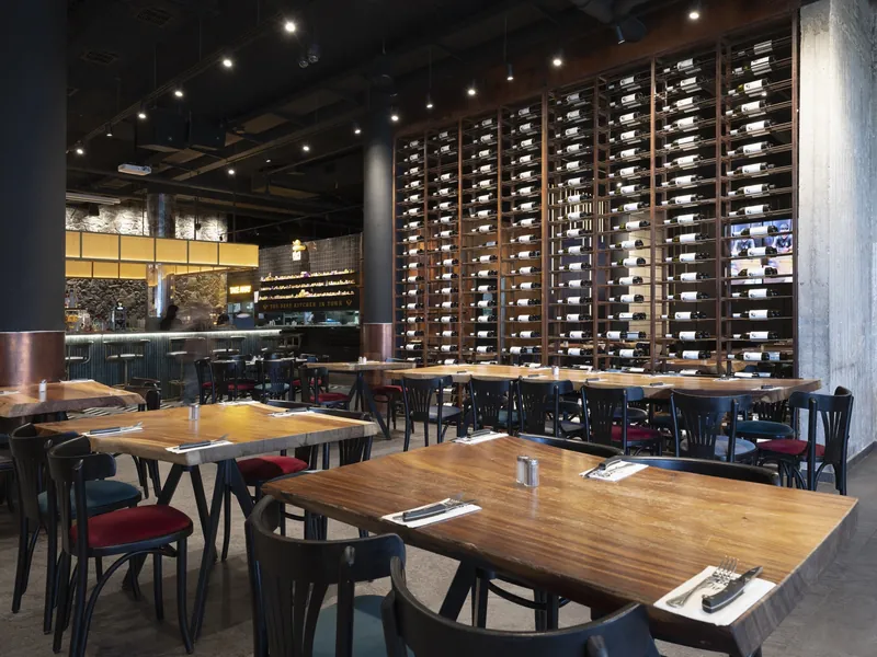 Dining room and wine wall at Ruben restaurant, Ashkelon. Photograph by STAS PRO