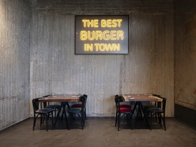 Neon sign on a concrete wall at Ruben restaurant, Ashkelon. Photograph by STAS PRO