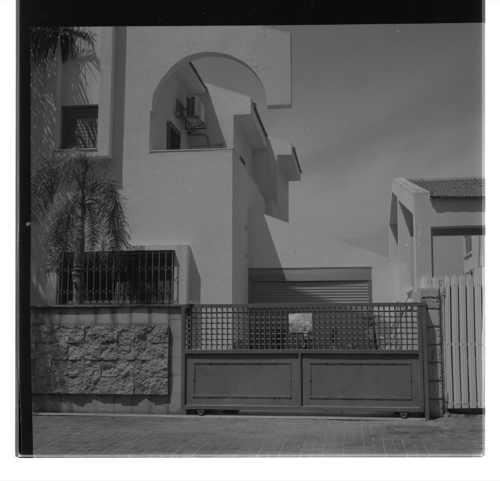 Contemporary white stucco residence with arched facade cutout — architectural photography by STAS PRO